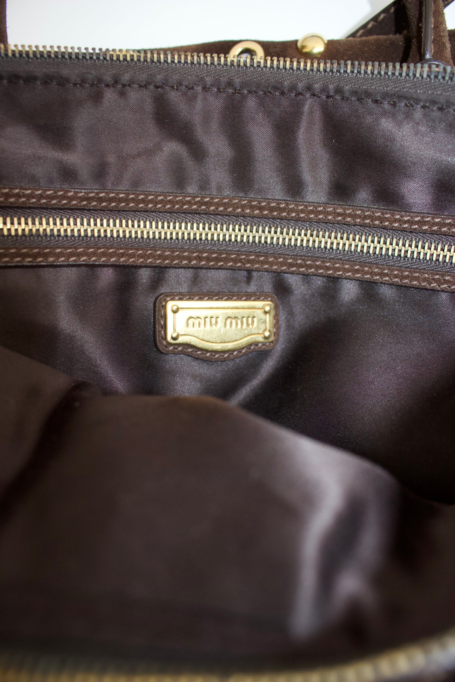Miu Miu brown suede bag with golden eyelets and grommets