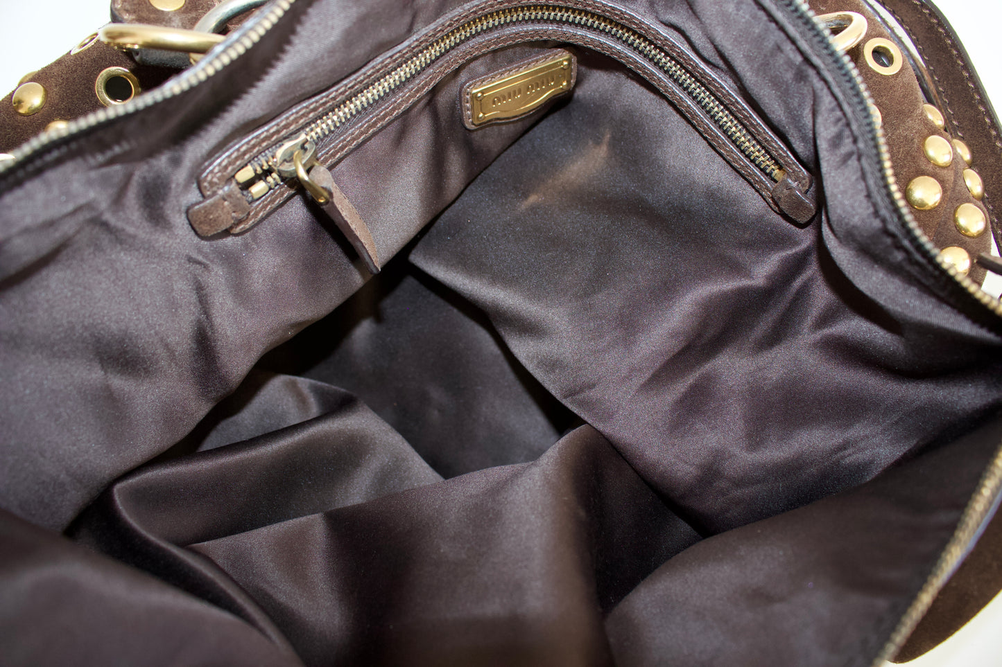 Miu Miu brown suede bag with golden eyelets and grommets